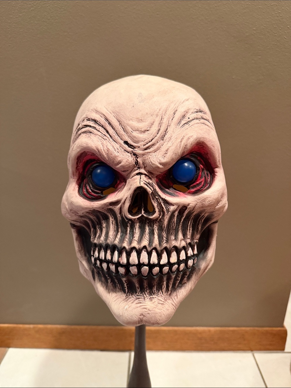 Grim reaper skull mask with piercing blue eyes